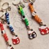 Llaveros Neko dije Metal , 7chakras y ojo turco